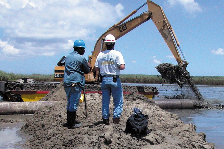 People working with soil in Louisiana