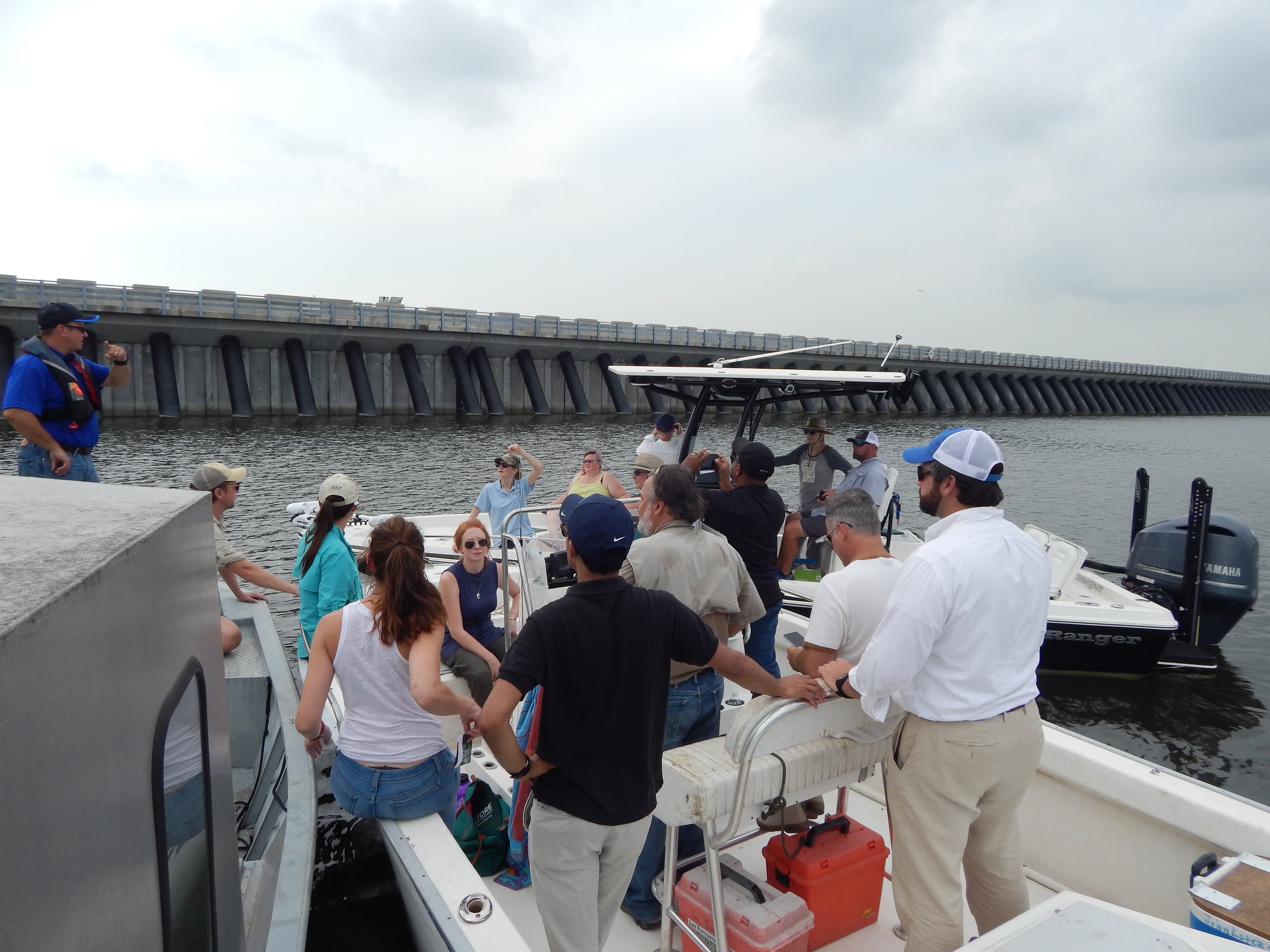 The group discusses the surge barrier and adjacent wetland restoration efforts