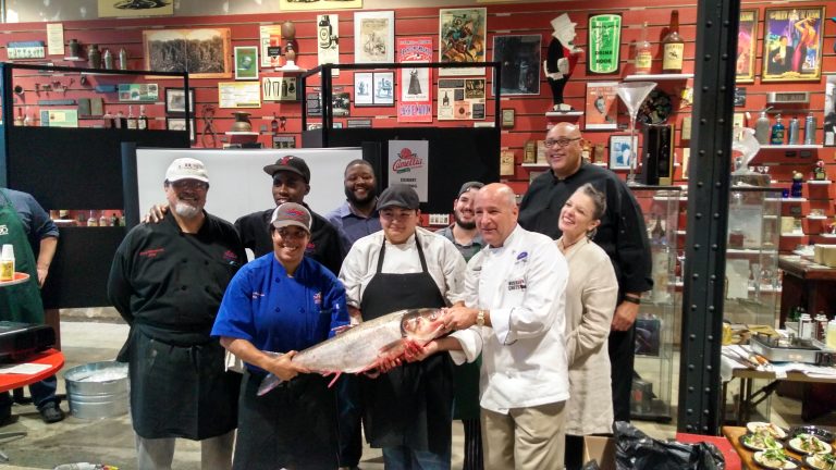 Winner Chef Jessica Richardson (in blue) shows off an Asian carp. Photo: Kelly Wagner